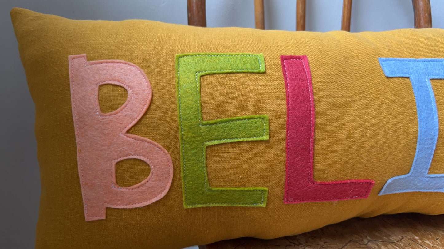 BELIEVE Christmas Pillow in Mustard Yellow Linen and Jewel Tone Letters